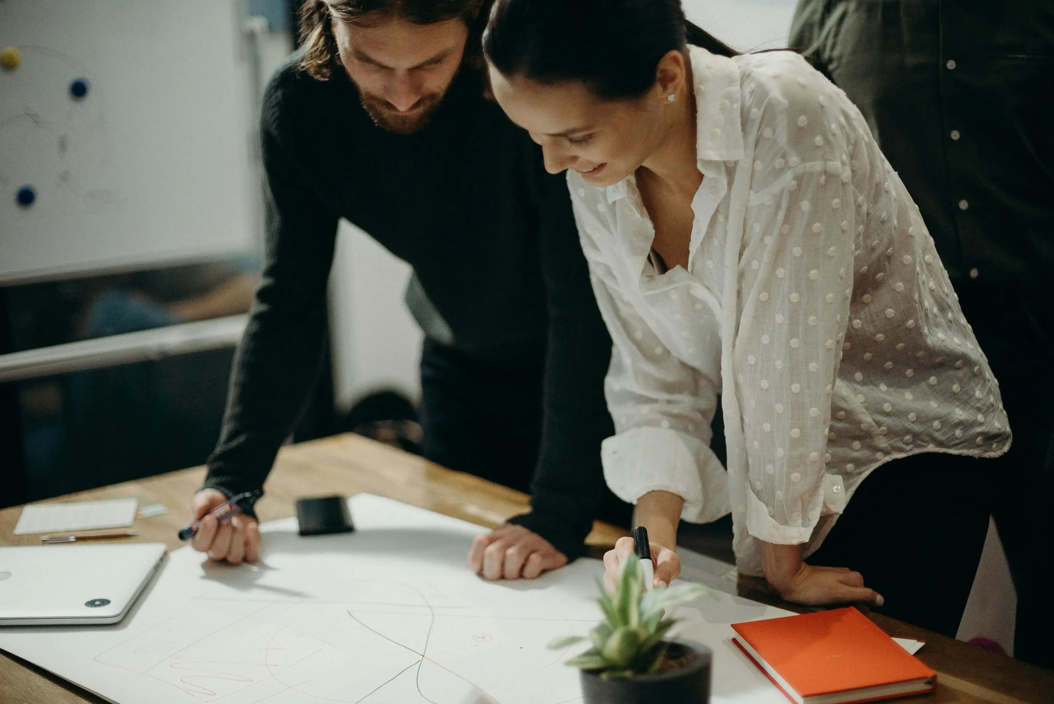 Two PMO team members charting their positive ROI. 